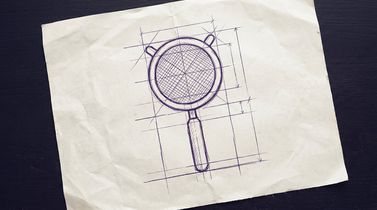 a handheld wire mesh strainer featuring a circular metal rim enclosing a fine wire mesh bowl and extending into a straight handle