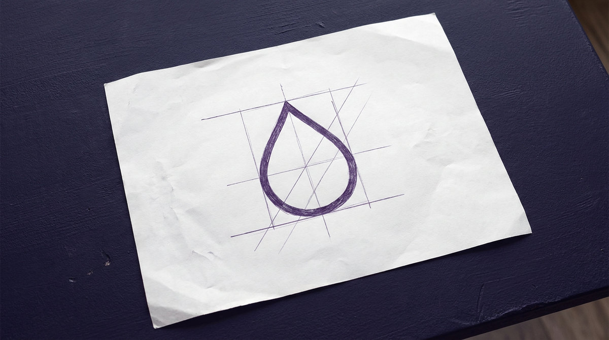 a single water droplet with a tapered pointed top and a smooth rounded bottom